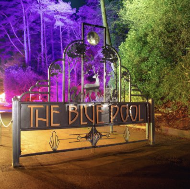 The Blue Pool gates illuminated at night
