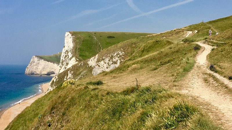 Walkers on the Dorset coastal path with sea views
